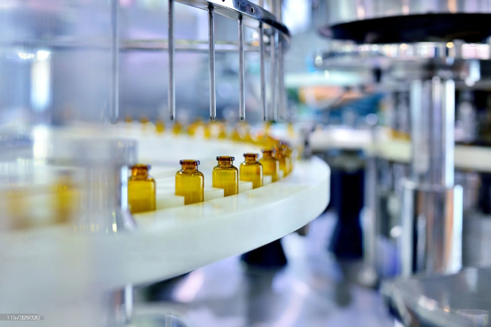 bottles being assembled and moved through a belt