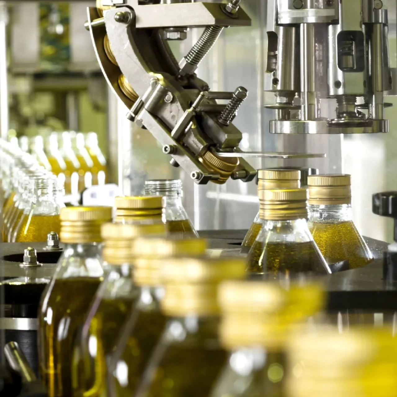 machinery filling all the glass bottles with liquid